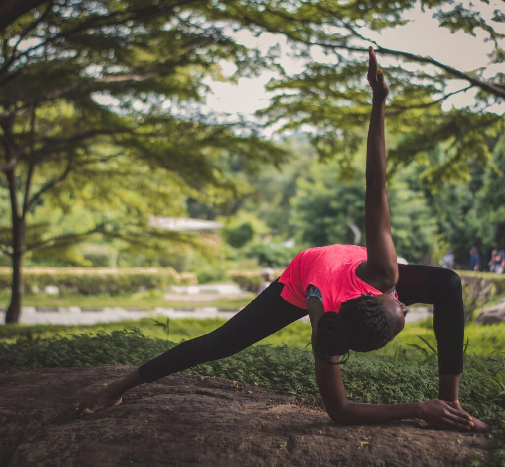 pexels-photo-2908057-2908057 A woman practicing yoga poses outdoors in Nigeria, showcasing flexibility and endurance.